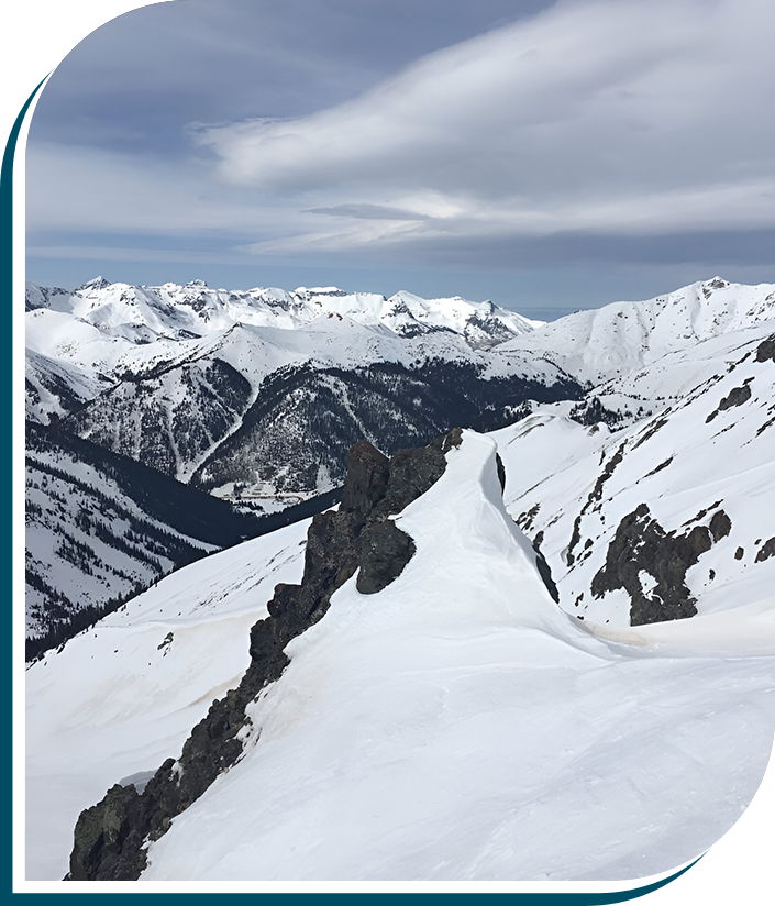 A person skiing down the side of a mountain.