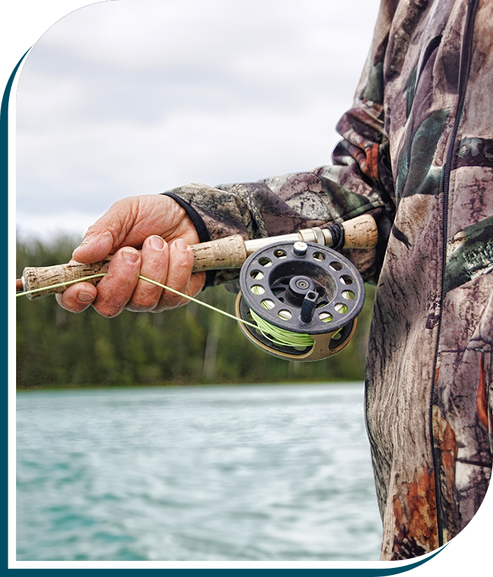 A man holding a fishing rod and reel.